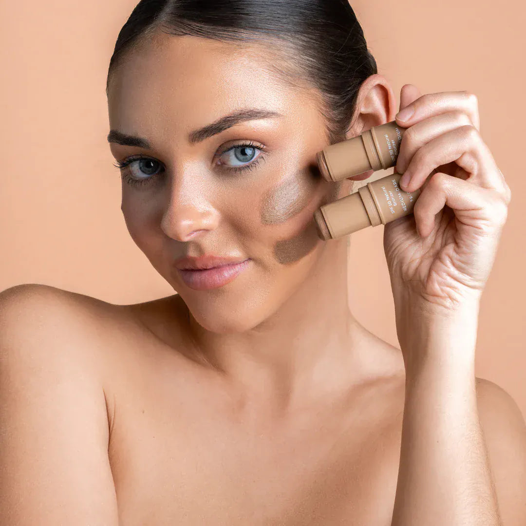 Woman applying Avocado Zinc SPF 50 Natural Bronzer for sun protection and glow