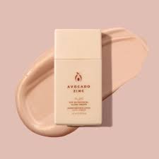 Avocado Zinc SPF 50 Bronzing & Glow Drops bottle on a creamy backdrop for sun protection and bronzed glow.