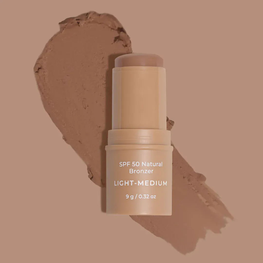 Avocado Zinc SPF 50 Natural Bronzer stick on warm brown background, offering sun protection and a natural bronzed glow.