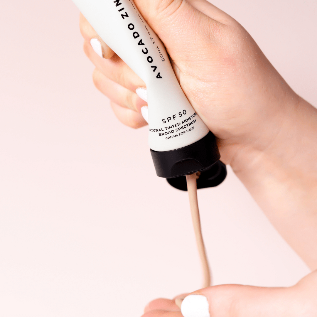 Applying Avocado Zinc SPF 50 Tinted Moisturiser Light–Medium 100ml for daily UV protection and skin hydration