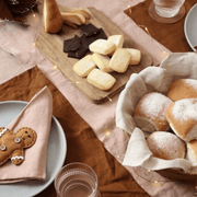 Linen Napkins Set 2 Blush styled with bread and desserts on a beautifully arranged dining table.