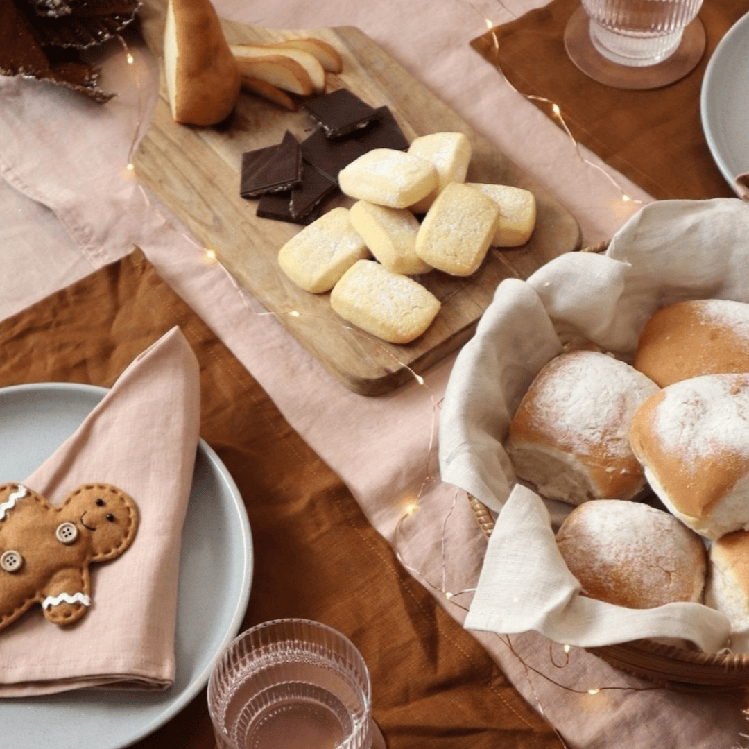 Linen Napkins Set 2 Blush styled with bread and desserts on a beautifully arranged dining table.