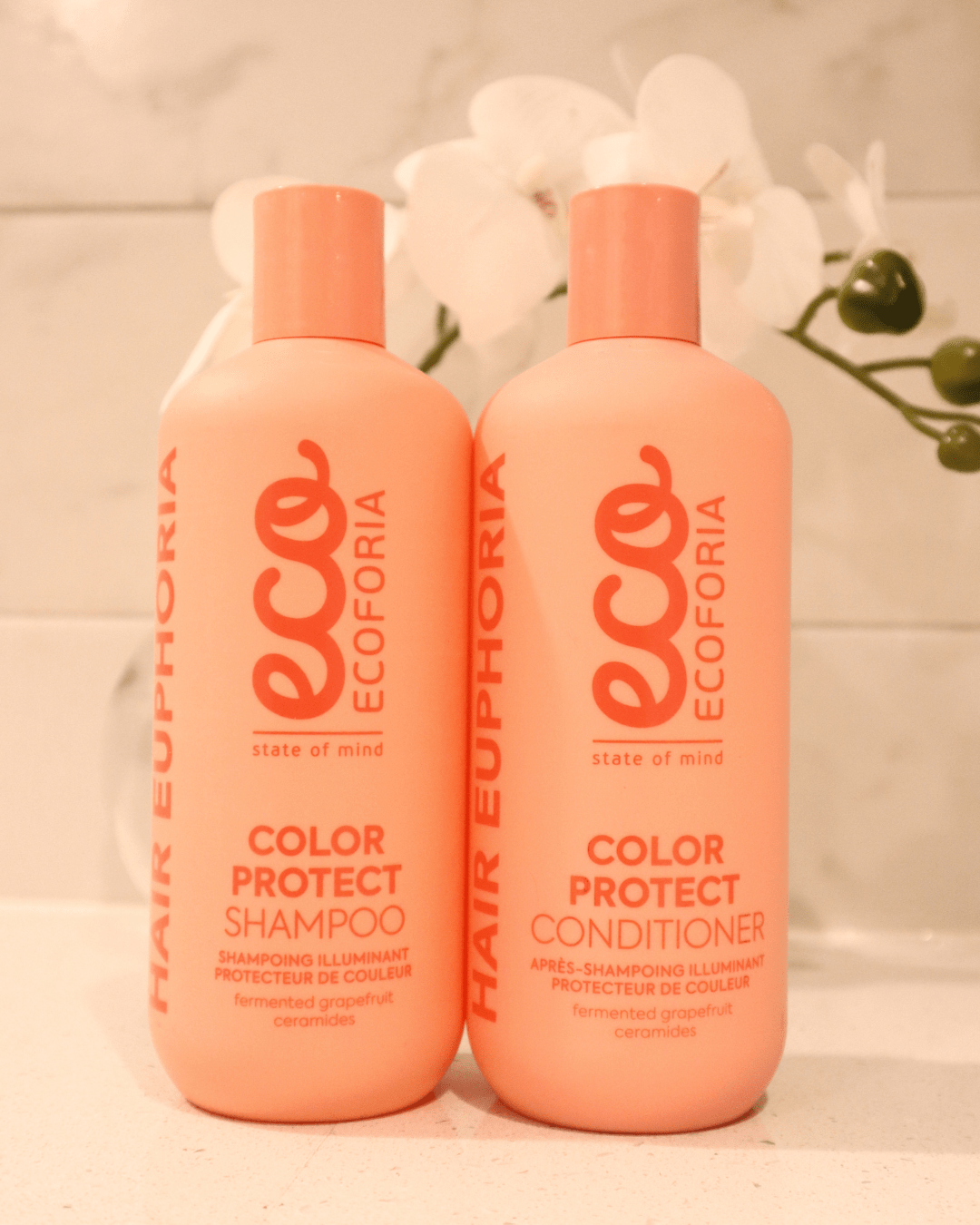 Ecoforia Colour Protect Conditioner 400ml next to shampoo, designed for color-treated hair, enhances softness and manageability.