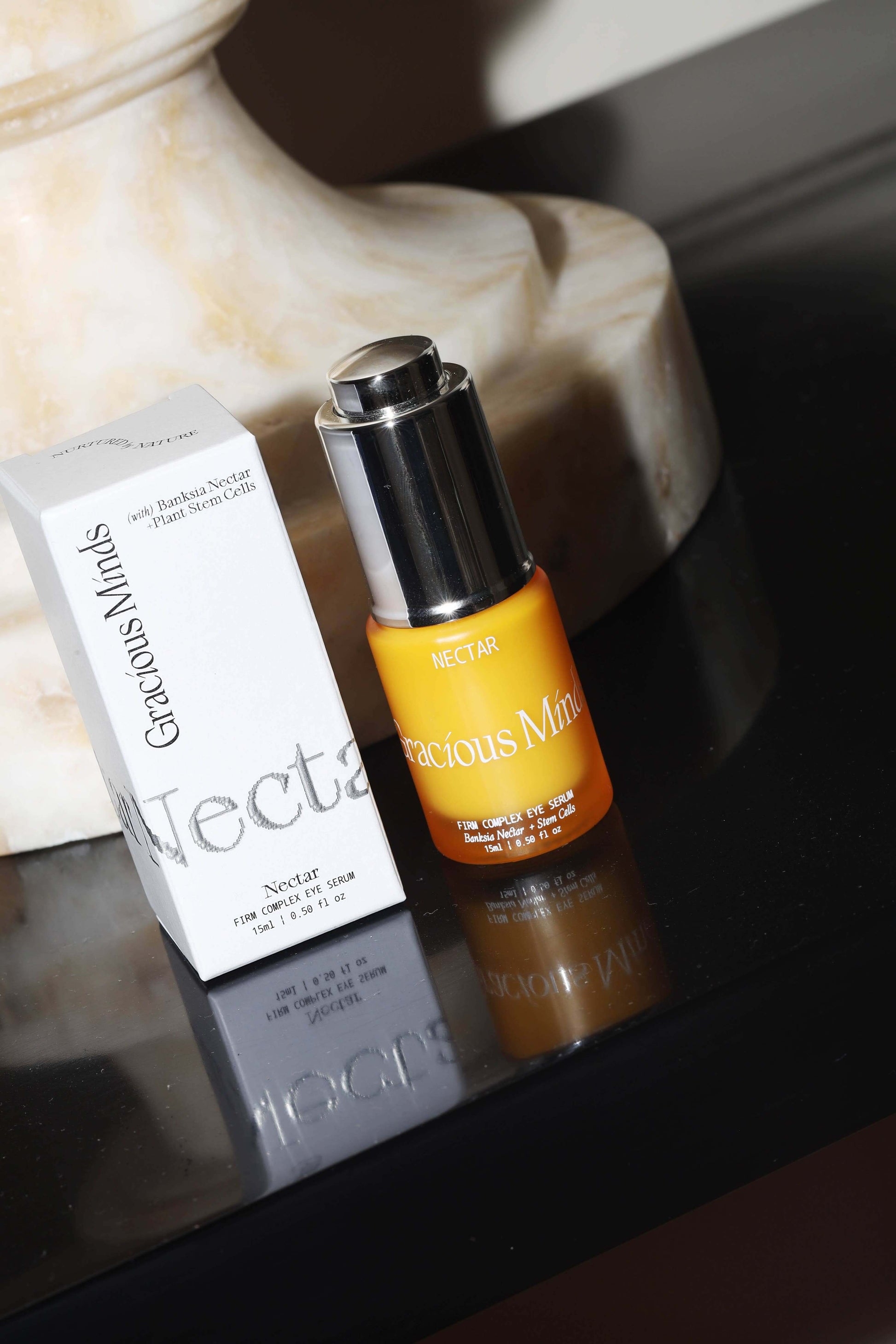 Gracious Minds Nectar Firming Eye Serum Elixir 15ml bottle and packaging on a table.