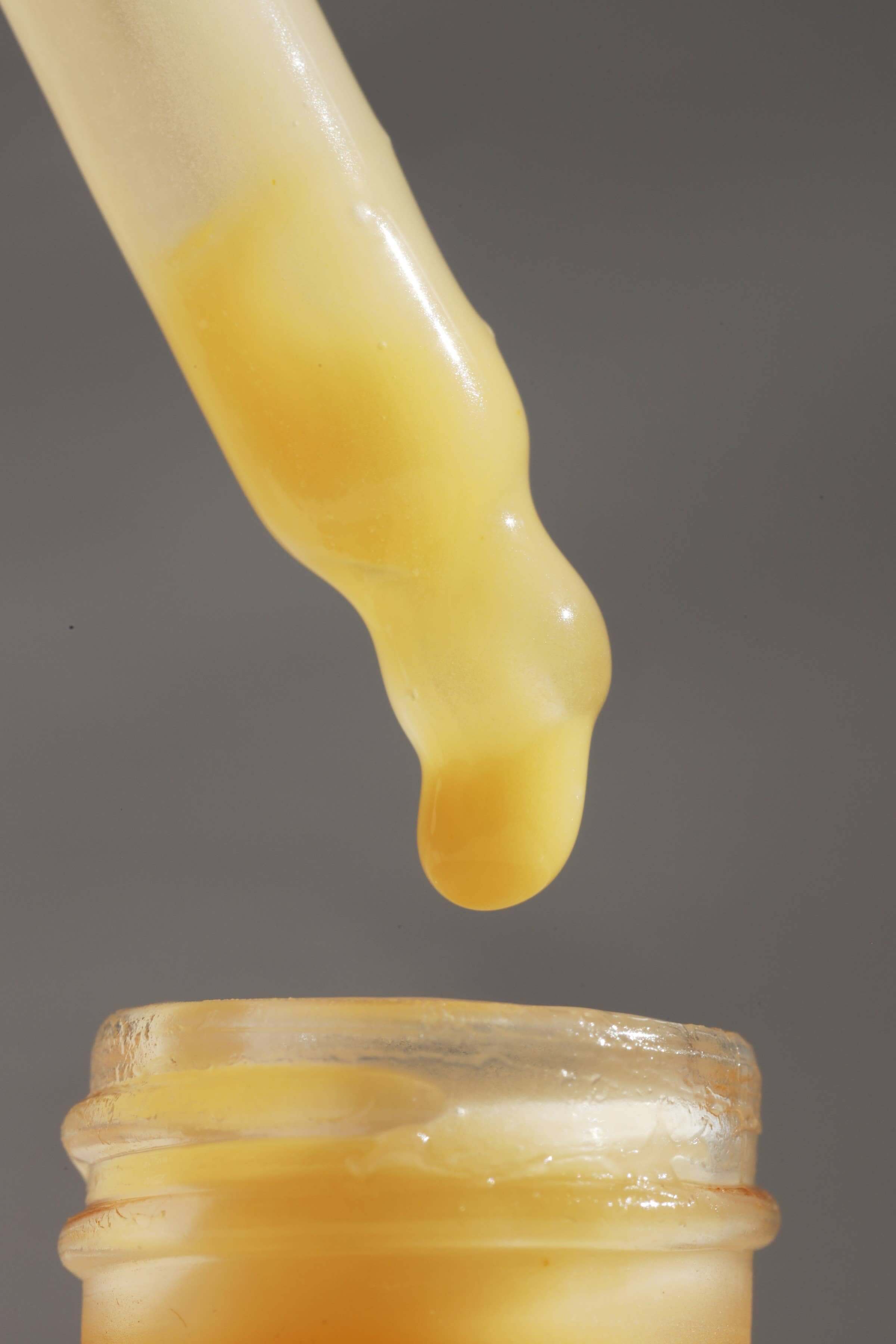 Gracious Minds Nectar Firming Eye Serum Elixir with dropper, close-up of golden liquid serum for eye treatment in glass bottle, 15ml