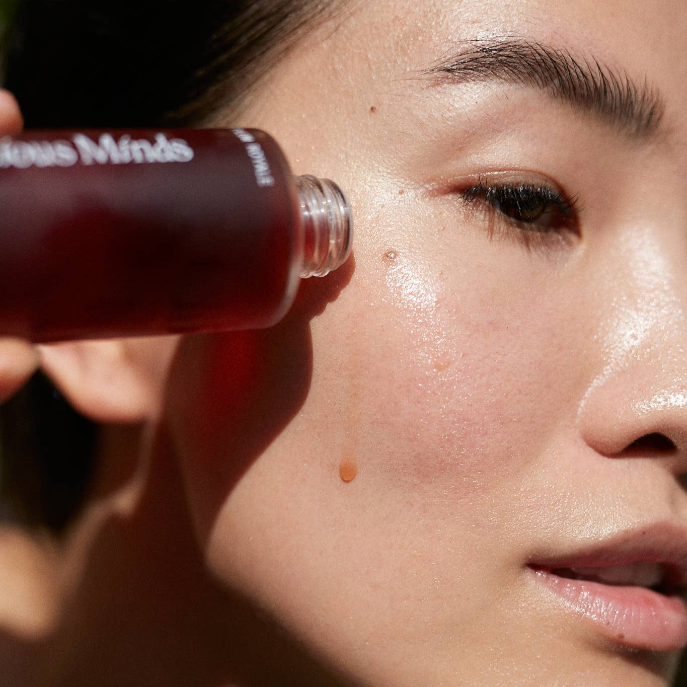 Applying Gracious Minds Plum Royale Superlative Antioxidant Concentrate for skin vitality and antioxidant protection.