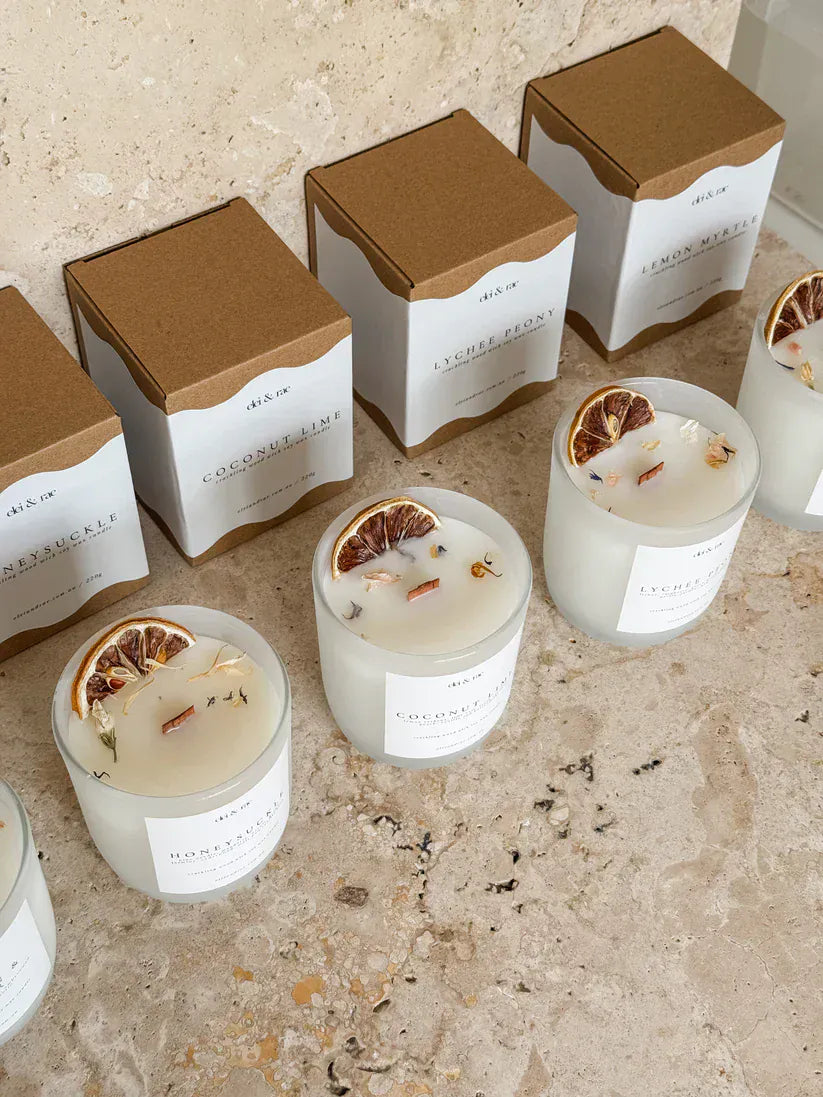 Coconut Lime Candle 220g Elei & Rae soy wax candles displayed on a countertop with decorative elements.