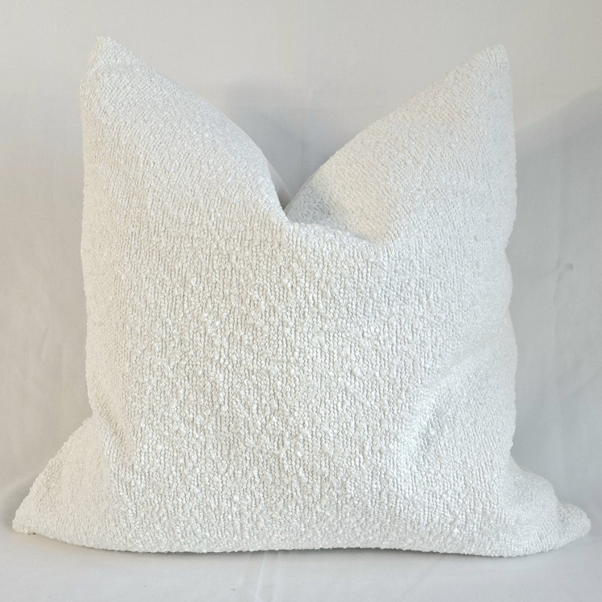 Boucle Cushion Cover Alabaster displayed in a soft textured design, enhancing home decor with elegance and comfort.