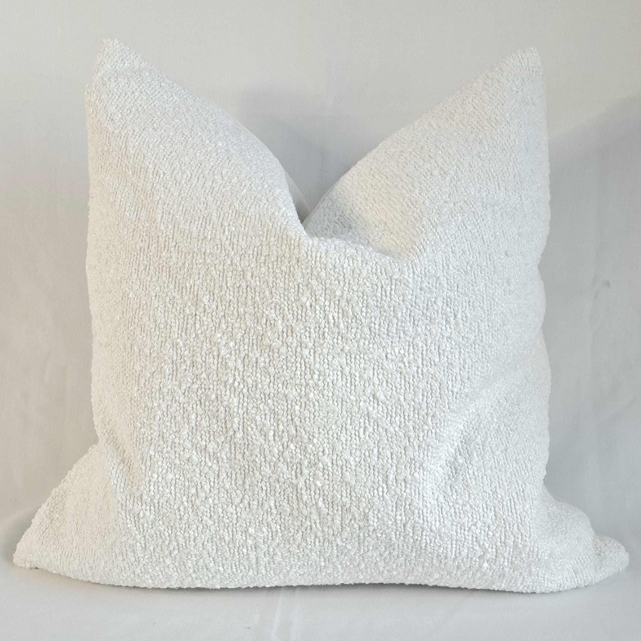 Boucle Cushion Cover Alabaster displayed in a soft textured design, enhancing home decor with elegance and comfort.