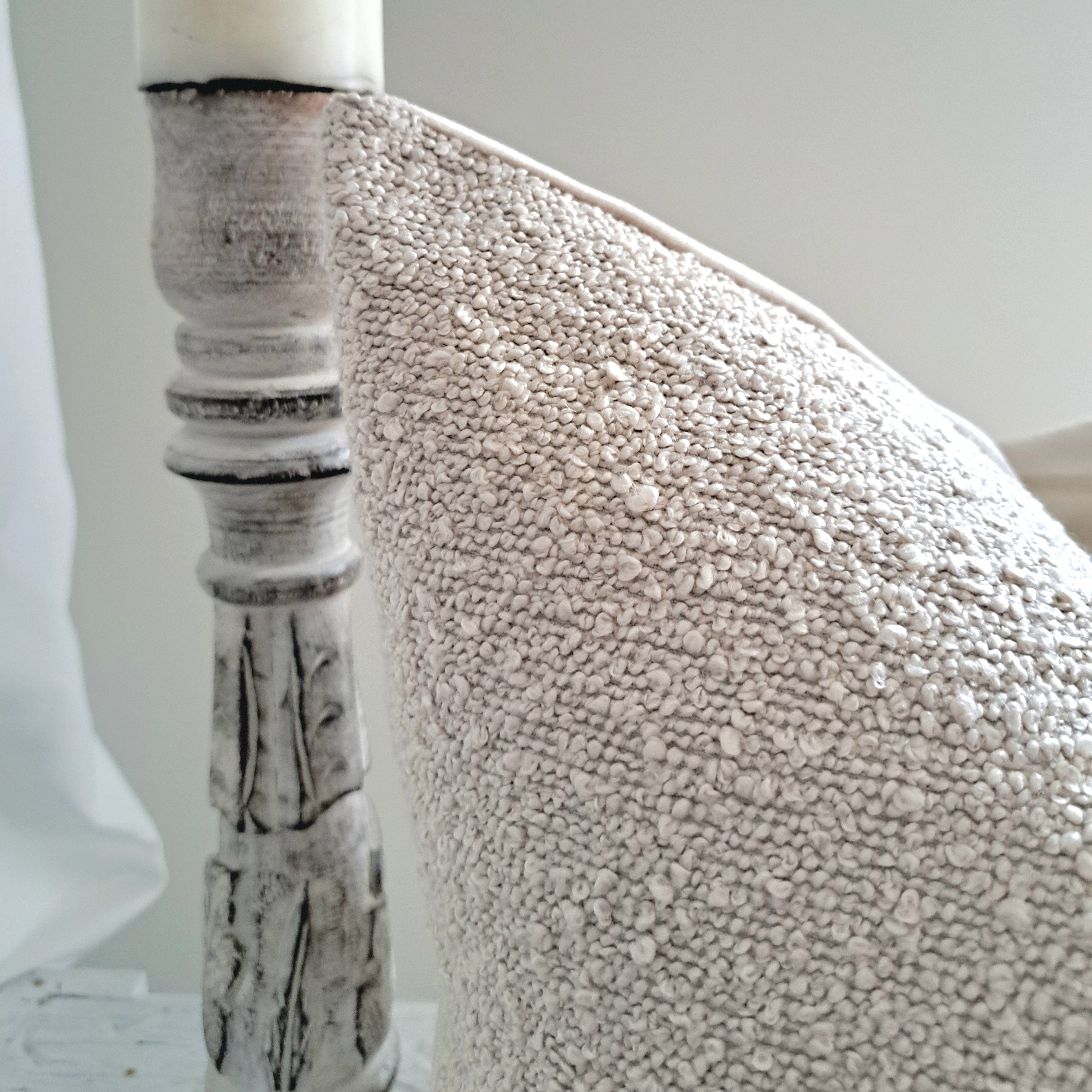 Boucle Cushion Cover Sepia showcasing soft textured finish next to a rustic wooden chair leg.
