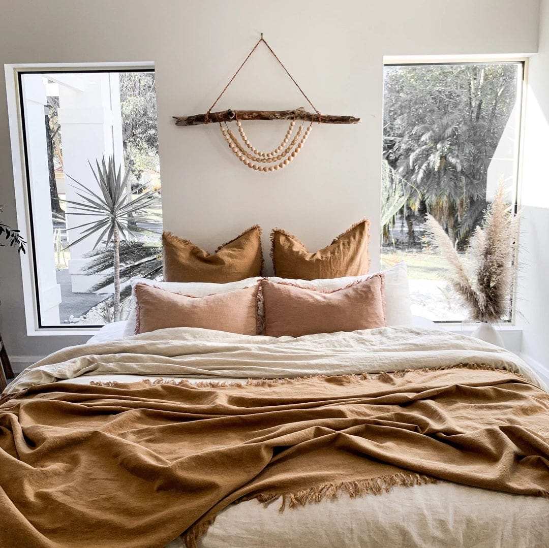 Lumbar Cushion Cover Blush Soft Decorative Accent in a cozy bedroom with natural decor and warm tones.