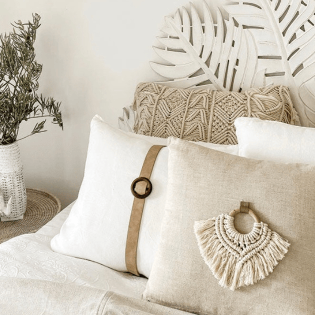 Nahla Macrame Cushion Accessory showcased among textured pillows and plants, enhancing boho decor in a cozy setting.