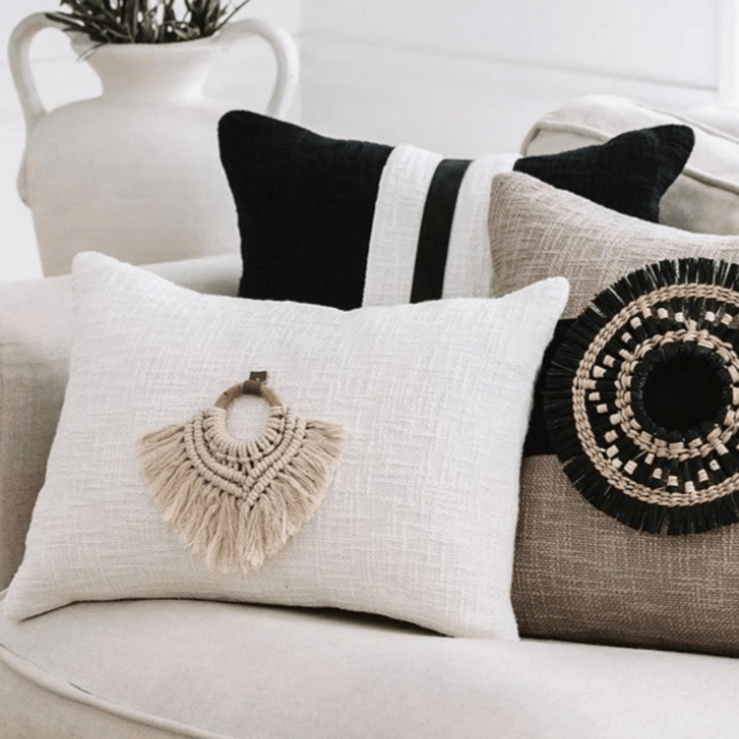 Nahla Macrame Cushion Accessory showcasing intricate macramé knots and tassel detail on a textured white cushion.