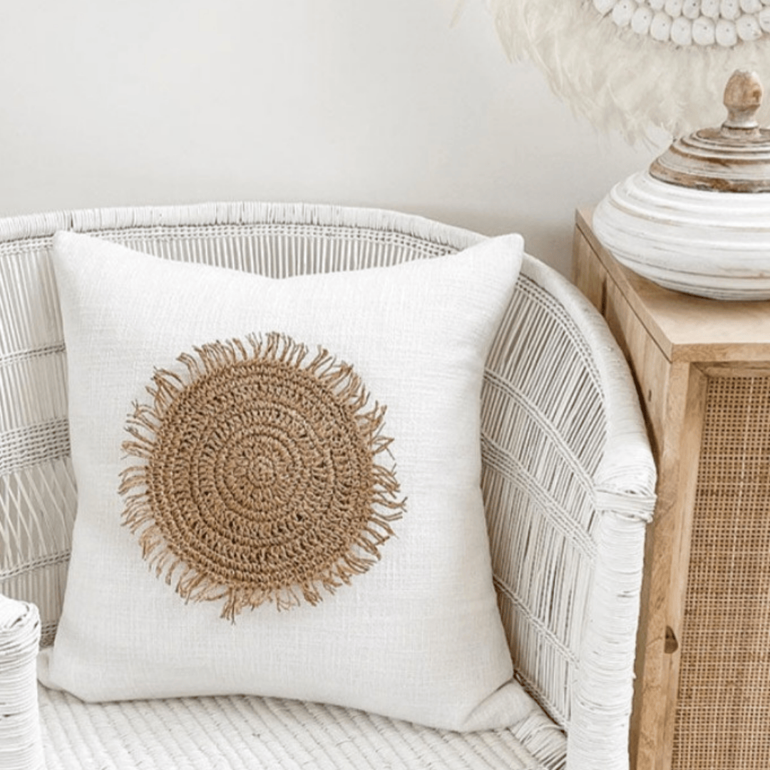 Solara Sun Cushion Disk on a cozy chair, featuring a caramel boho decor design with a textured round fringe pattern.
