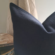 Base Cushion Black on a wooden surface, showcasing its textured fabric and elegant design for home decor.