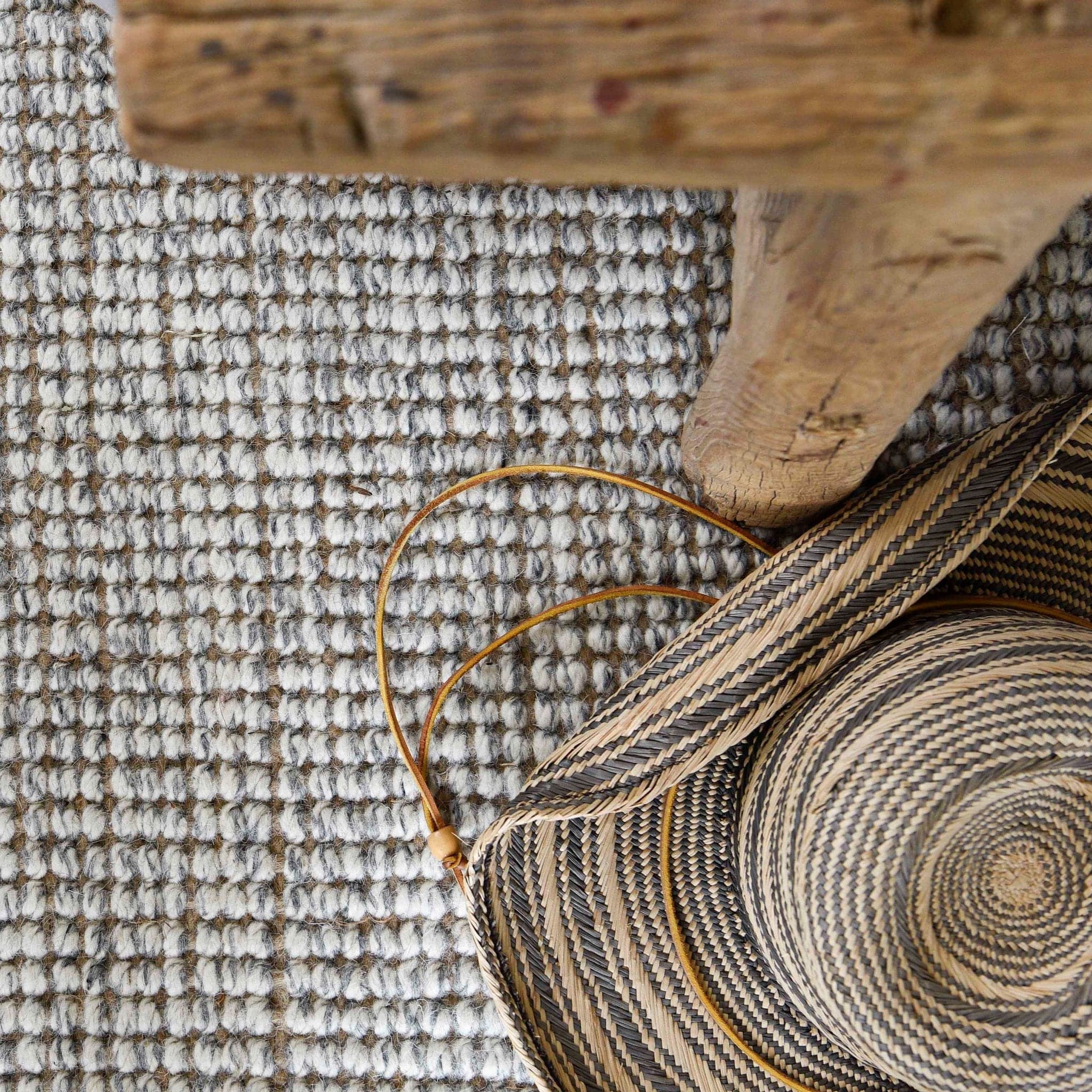 Jute Wool Rugs & Runners with a natural woven texture, featuring a woven basket and wooden table.