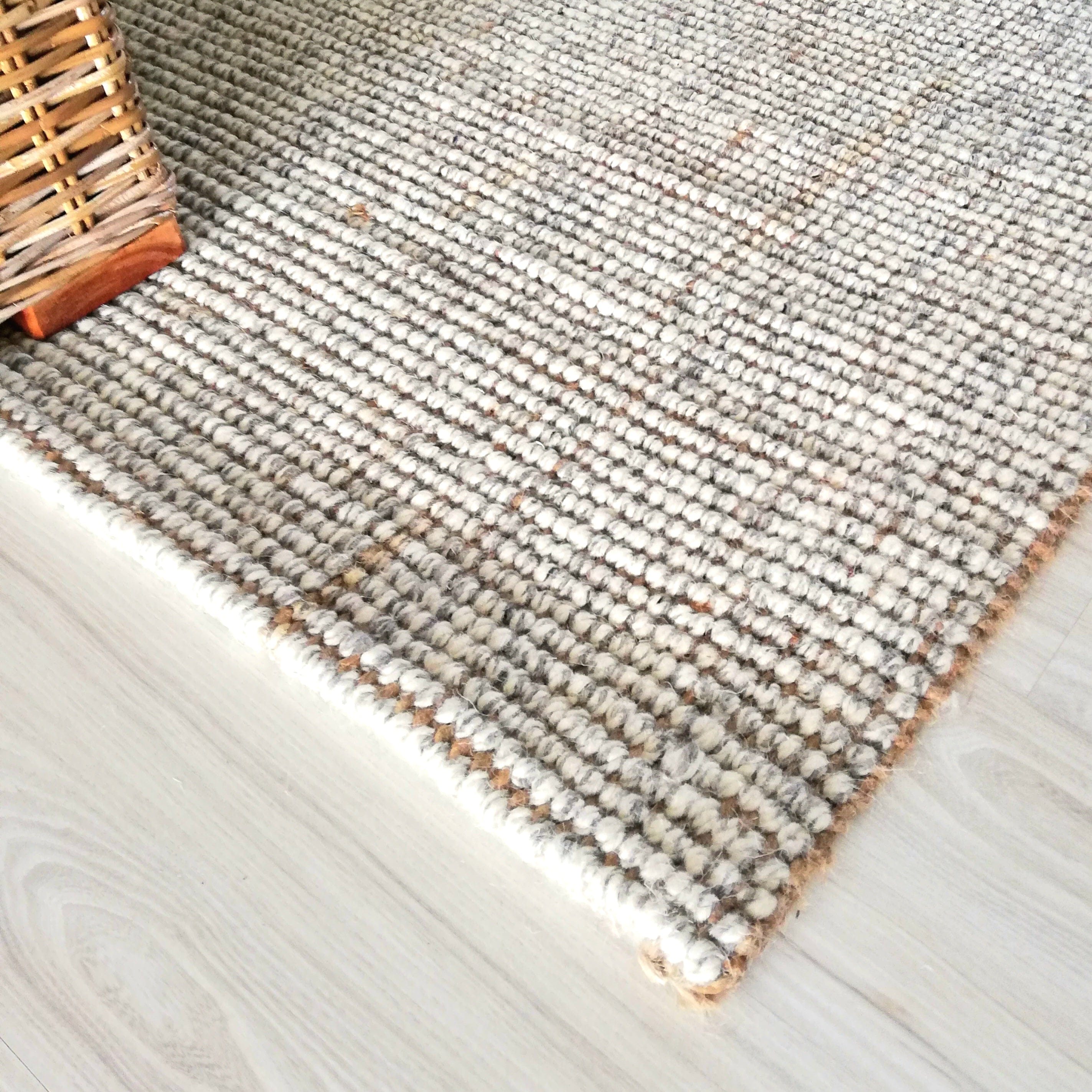 Natural textured Jute Wool Rugs & Runners on wooden floor, showcasing durable and soft design.