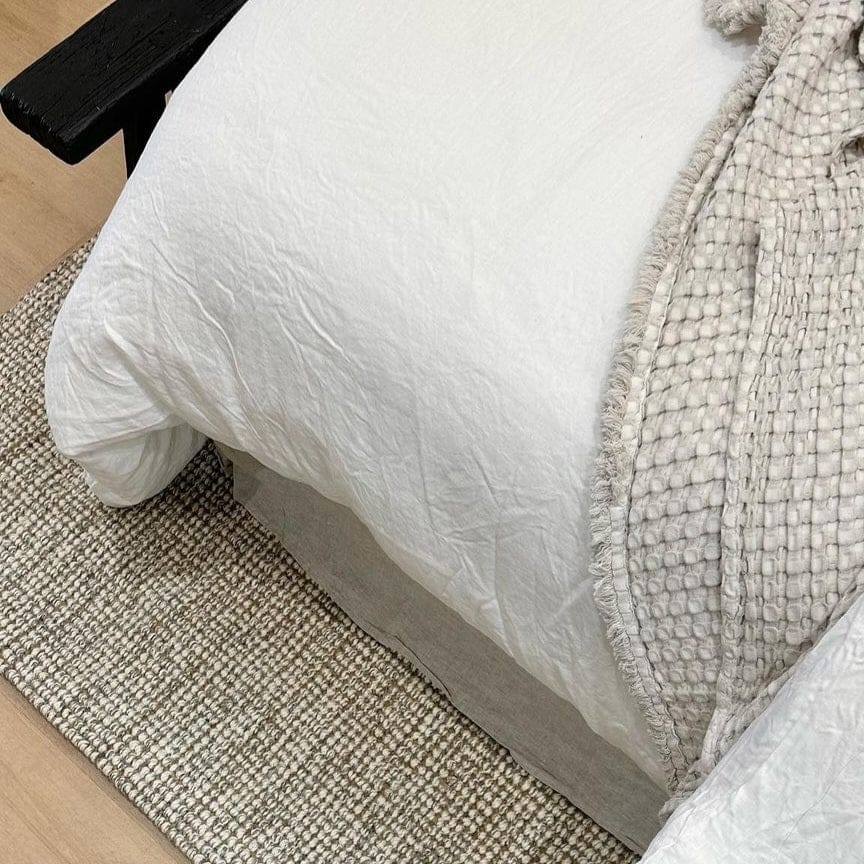 Jute Wool Rugs & Runners underneath a bed with a textured blanket creating a cozy home decor atmosphere.