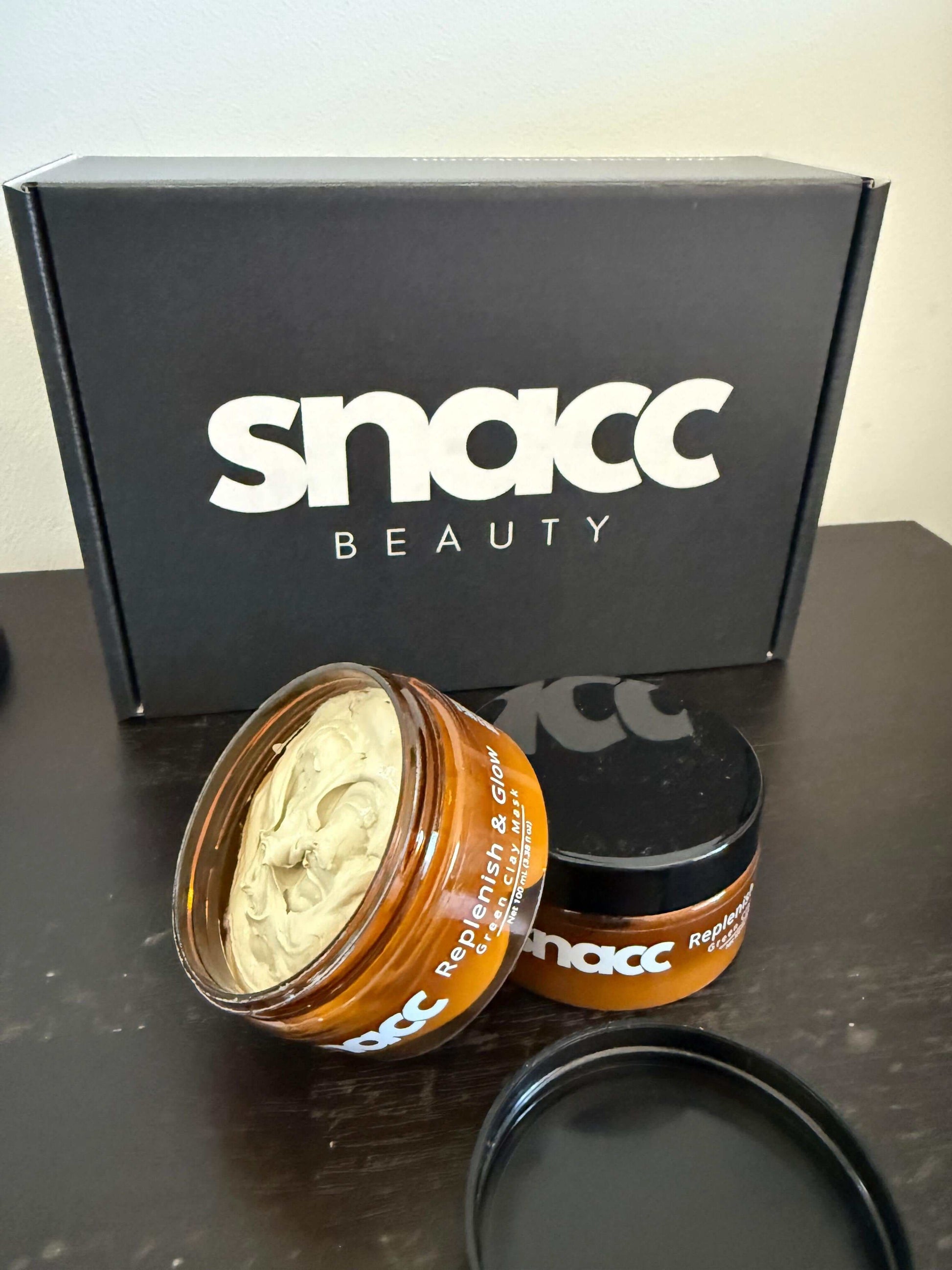 SNACC Beauty Replenish & Glow Green Clay Face Mask open jar with packaging