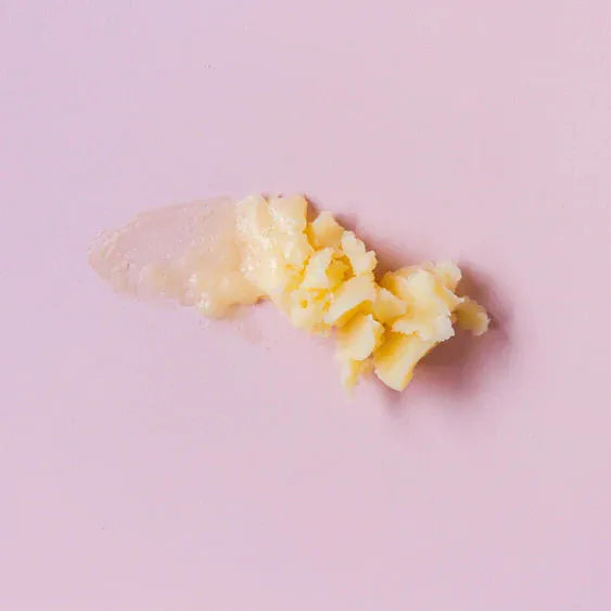 Nourish My Lips Lip Balm 15ml texture showing creamy and hydrating formula on a pink background.