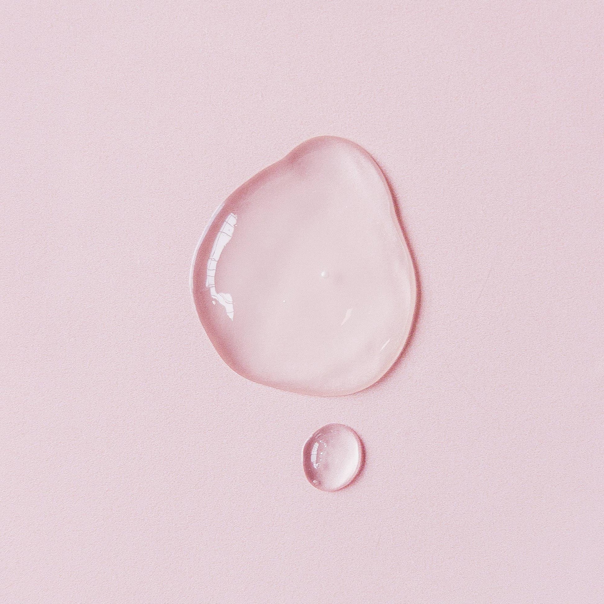 Texture of Summer Salt Body Magnesium Sleep Spray showing light and absorbent qualities on pink background