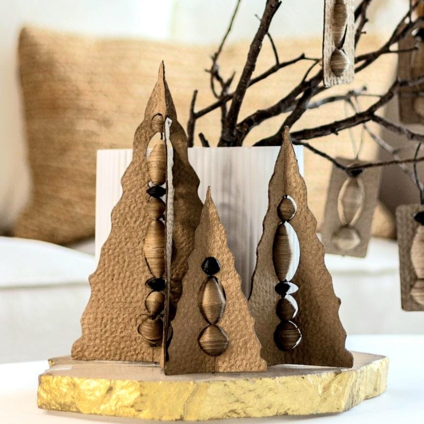 Paper Handmade Christmas Trees Natural Festive Decor Set displayed on a gold-trimmed table, enhancing minimal holiday decor.