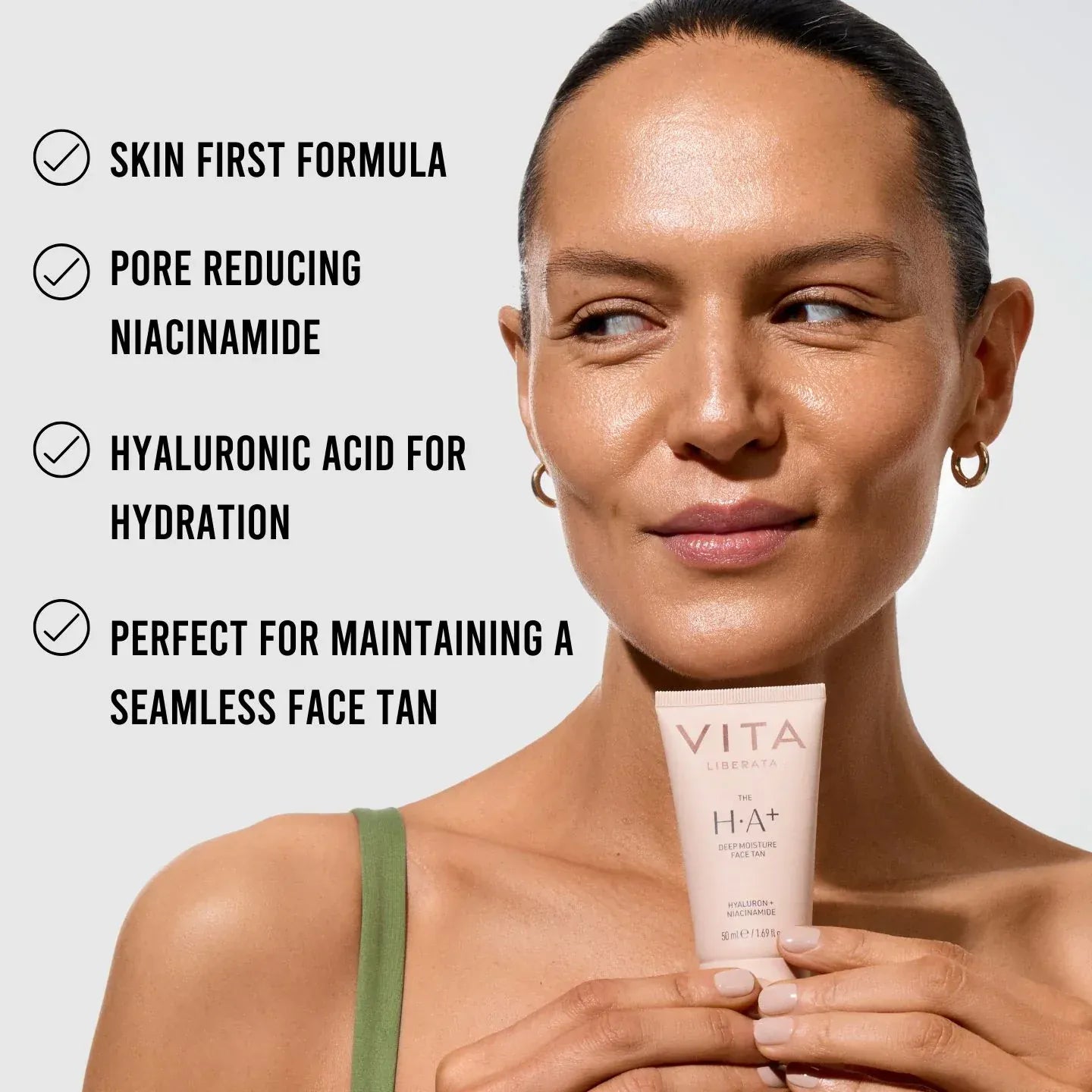 Woman holding Vita Liberata HA + Deep Moisture face tan serum with listed benefits for hydration and seamless tan.