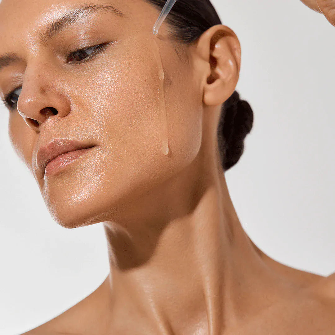 Woman applying Vita Tanning Anti-Age Face Serum for natural glow and hydration