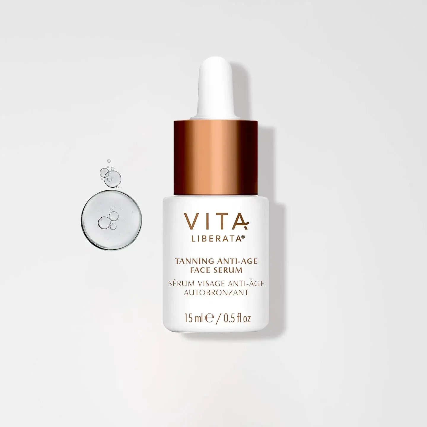 Vita Tanning Anti-Age Face Serum bottle on white background with hydration bubbles, ideal for a natural glow and anti-aging benefits.