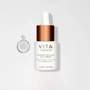 Vita Tanning Anti-Age Face Serum bottle on white background with hydration bubbles, ideal for a natural glow and anti-aging benefits.