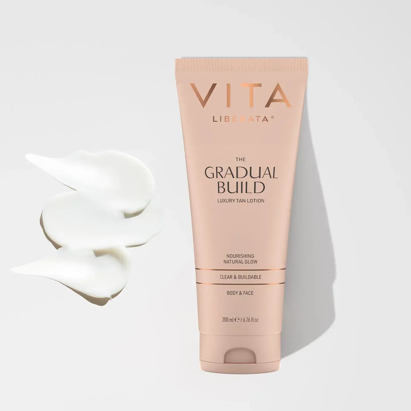 The Gradual Tanning Lotion 200ml hydrating glow builder with cream texture visible beside the product packaging.