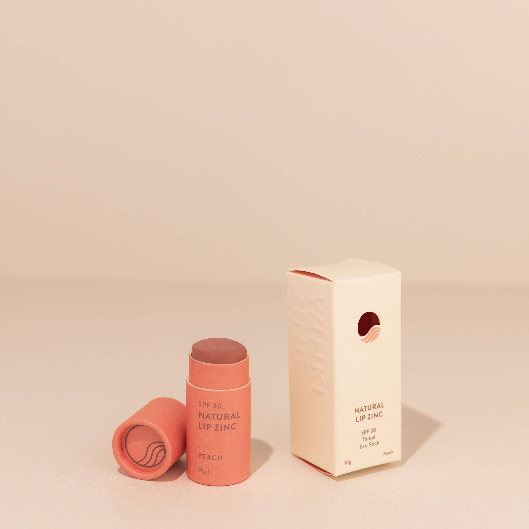 Winki Zinc Tinted Natural Lip Zinc in peach shade with box, SPF 30, mineral-based lip balm for sun protection and hydration.
